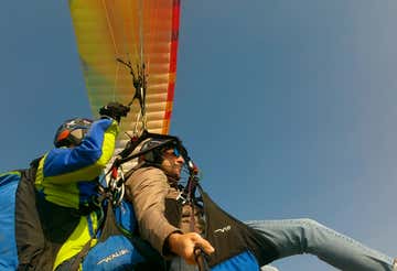 Tandem paragliding flight over the hills of Tivoli