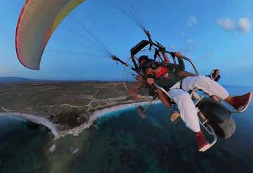 Tandem paramotor flight over the Sinis Coast at sunset