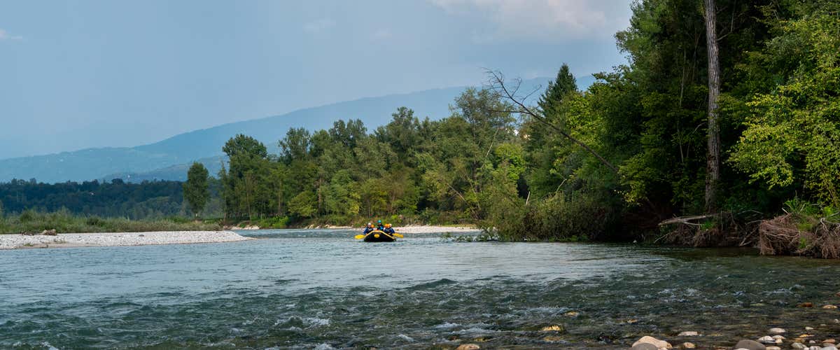 Winter rafting adventure on the Cordevole river in the Dolomites